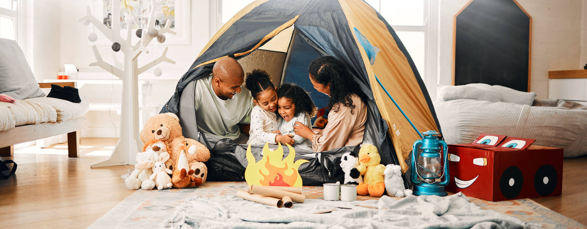 Family playing in their tent in the living room